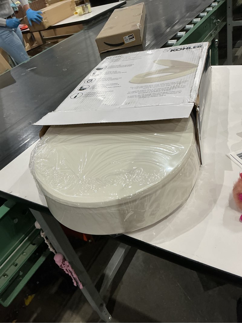 Condition photo showing Good Condition for kohler 25876-96 hyten 3" height, elevated soft close round toilet seat, contoured seat with grip-tight bumpers, quick-attach hardware, biscuit biscuit round