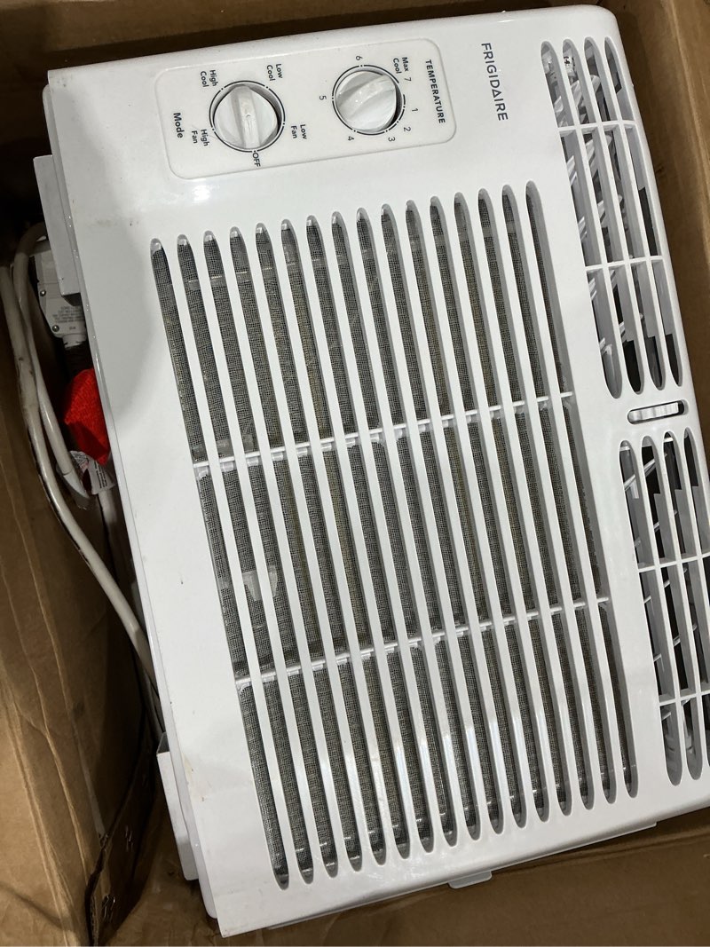 Condition photo showing As Is for frigidaire 5,000 btu window-mounted air conditioner, cools up to 150 sq. ft., quiet operation, effortless temperature control, 2 fan speeds, auto restart, white 5,000 btu mechanical controls
