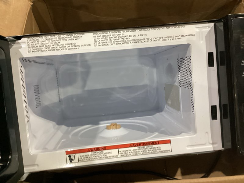 Condition photo showing As Is for chefman countertop microwave oven 0.7 cu. ft., 700 watts with 10 power levels, 6 cooking presets with one-touch express cook, eco mode, child safety lock, & mute button - black