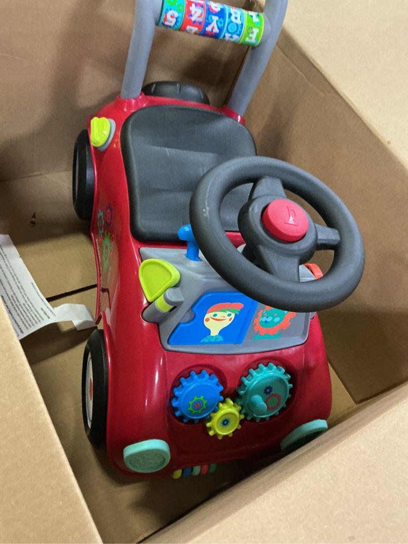 Condition photo showing As Is for Radio Flyer Busy Buggy Ride On Toy Car with 17 Interactive Activities, Sit-to-Stand for Ages 1-3, Features Built-in Storage, Walk or Ride Options for Toddler Development and Play Lights & Sound