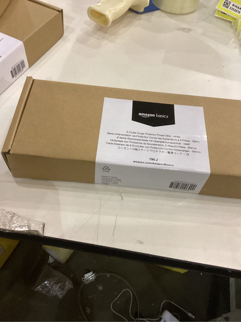 Condition photo showing New/Like New for Amazon Basics 6-Outlet Surge Protector Power Strip, 6-Foot Long Cord, 790 Joule - White (B00TP1C1UC)