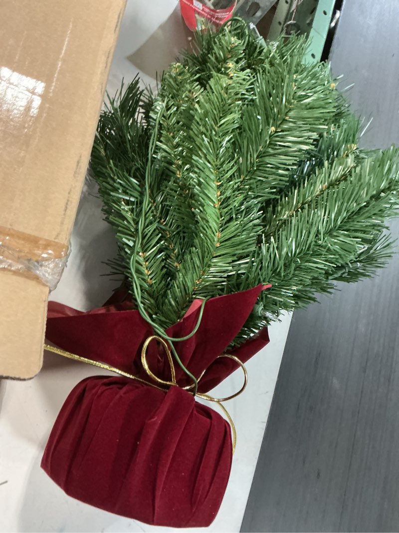 Condition photo showing Good Condition for national tree company 24 in pre-lit majestic fir mini artificial christmas tree, 35 clear lights, 71 tips, red cloth base, green plug in w/red bag tree