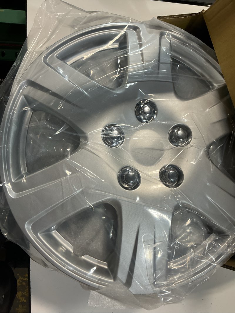 Condition photo showing New/Like New for four abs plastic silver colored hubcaps - 15 inch diameter