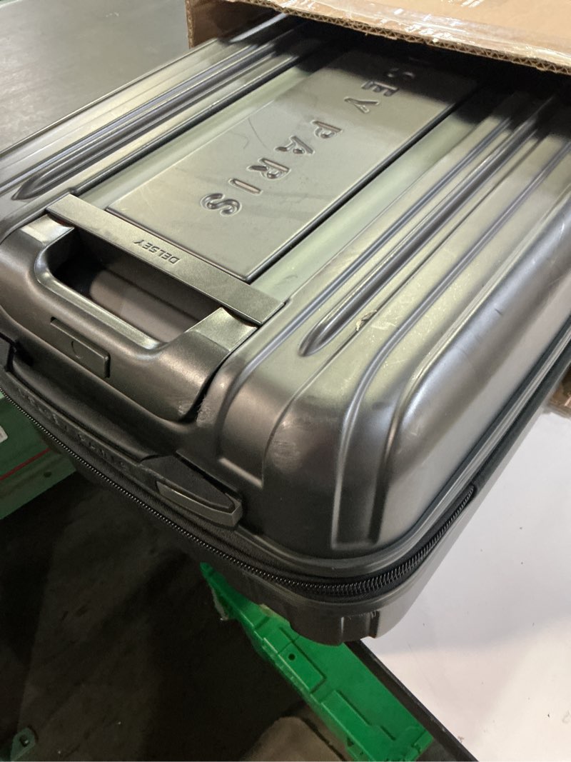 Condition photo showing As Is for DELSEY PARIS Titanium Hardside Expandable Luggage with Spinner Wheels Carry-On Luggage, Graphite, Carry-On 21 Inch Carry-On 21 Inch Graphite