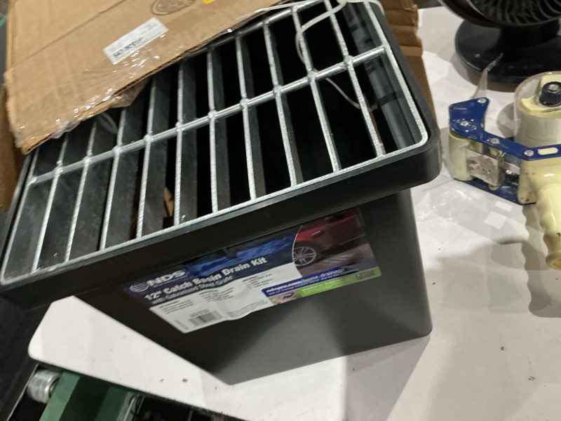 Condition photo showing As Is for 12 in. square catch basin drain kit with 2-opening catch basin steel grate 2-outlet adapters 1-outlet plug