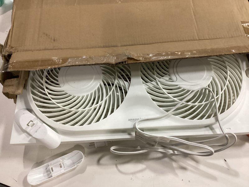 Condition photo showing As Is for Amazon Basics Window Fans for Home Bedroom, Twin Heads, Cooling Airflow, Exhaust, Expandable Side Panel Manual Control, 3 Speeds, 63W, 9 inch, White