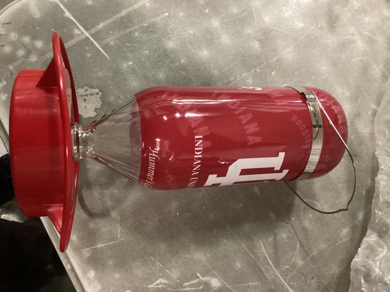 Condition photo showing Good Condition for Hummer's Galore, NCAA College Football Hummingbird Feeder, Glass Hummingbird Feeder with UV Resistant Plastic Wrap for Outdoors Hanging, 32 oz, (Indiana University)