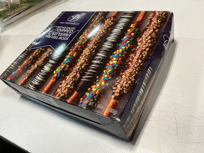 Condition photo showing New/Like New for (BEST BY 03/15/2026)Mrs Prindables 24 Chocolate Dipped Caramel Pretzel Rods