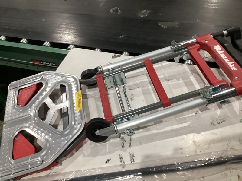 Condition photo showing As Is for milwaukee hand trucks 73333 fold-up convertible hand truck, 4-piece frame, compact storage, 300 lb capacity, red