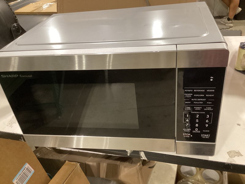 Condition photo showing As Is for sharp countertop microwave oven with removable 10.6" carousel turntable, 900 watt, 0.9 cubic feet, stainless steel with child lock