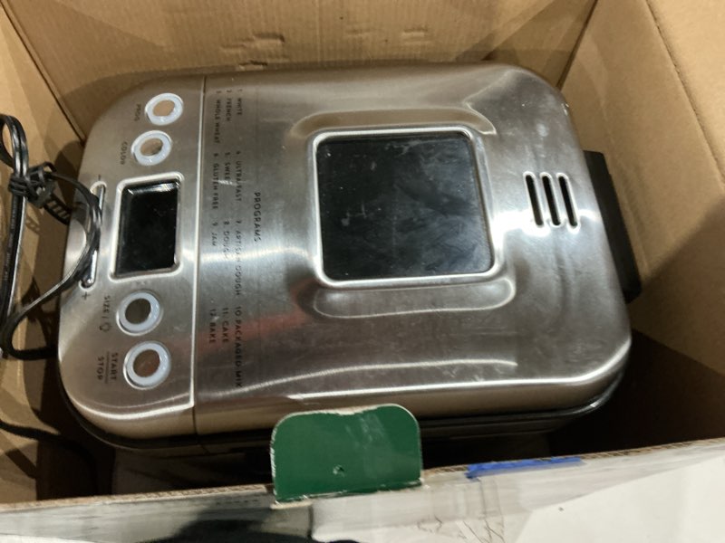 Condition photo showing As Is for cuisinart bread maker machine, stainless steel automatic bread machine with 12 menu options, 3 loaf sizes up to 2 lb., 3 crust colors, removable nonstick baking pan & kneading paddle, cbk-110nas