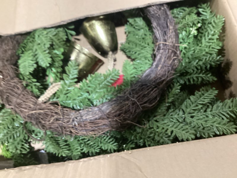 Condition photo showing As Is for National Tree Company Artificial Christmas Wreath, Green, Bells Pine, Red Ribbon, Pinecones, Metal Bells, 28 inch