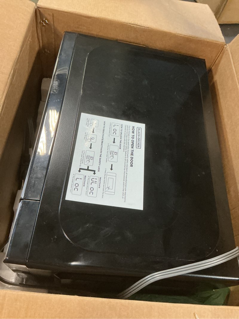 Condition photo showing As Is for black+decker em720cb7 digital microwave oven with turntable push-button door, child safety lock, 700w, stainless steel, 0.7 cu.ft 0.7 cu. ft.