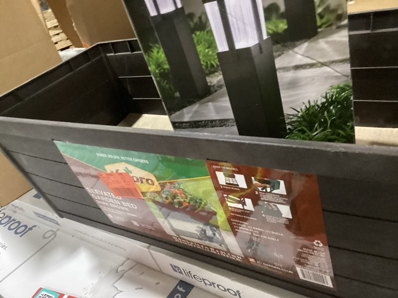 Condition photo showing As Is for vigoro 32.25 in. w x 31 in. h elevated resin patio garden bed in brown