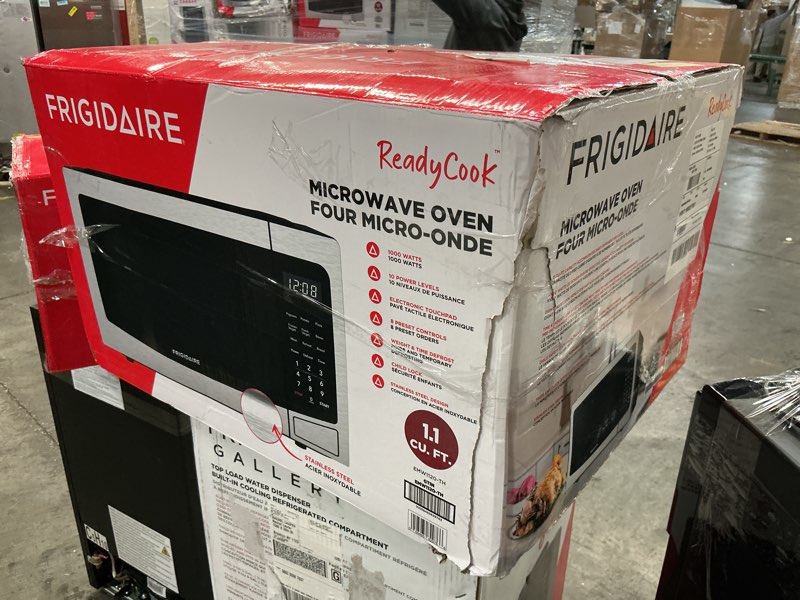 Condition photo showing As Is for Frigidaire EMW112OAMZ Stainless Steel Microwave Oven, Multi Function, Programmable, 1.1 Cu Ft 1000-Watt, residential kitchen, Stainless