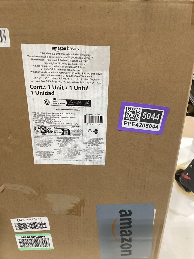 Condition photo showing As Is for amazon basics 21" hardside carry-on luggage, hardshell suitcase with wheels, expandable for up to 25% more space, with scratch-resistant surface, four multi-directional wheels, navy blue navy blue carry-on