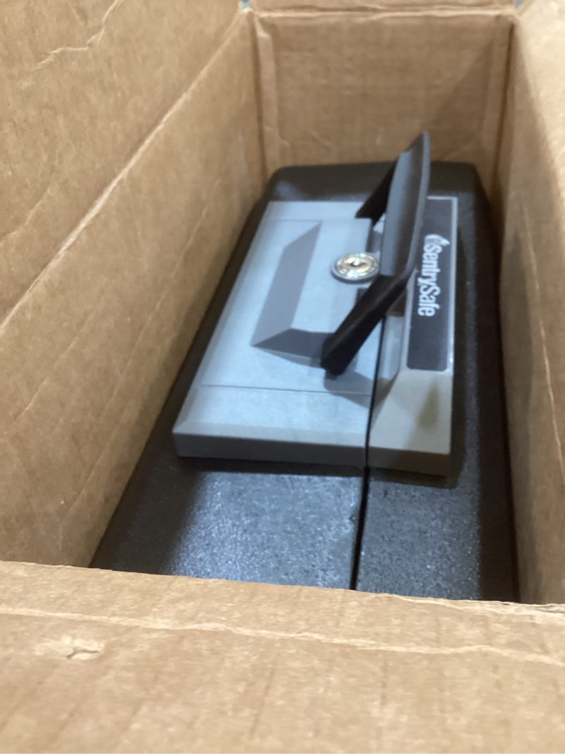 Condition photo showing As Is for sentrysafe fireproof safe box with key lock, chest safe with carrying handle to secure money, jewelry, documents, 0.25 cubic feet, 6.3 x 15.3 x 12.1 inches, 1160