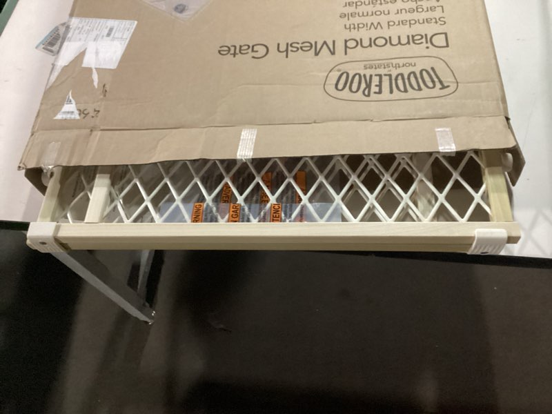 Condition photo showing As Is for Toddleroo by North States Diamond Mesh Wooden Baby Gate: 26.5"- 42" Wide. Pressure Mounted Baby Gate for Doorway. (23" Tall, Sustainable Hardwood)