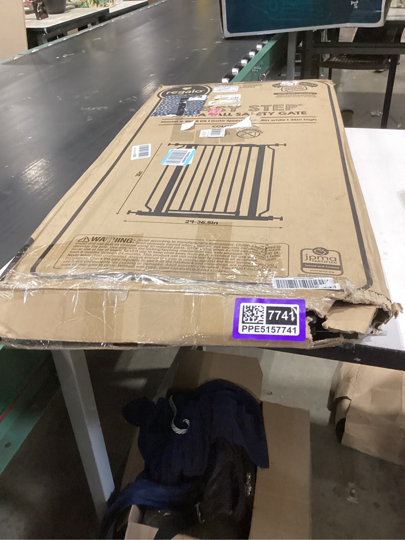 Condition photo showing As Is for regalo safety 36" extra tall baby gate for doorways & bottom of stairs, pressure mounted walk through gate for babies, toddlers & pets, tested & safe for 30 years, american designed, american owned black 29-36.5"w x 36"h