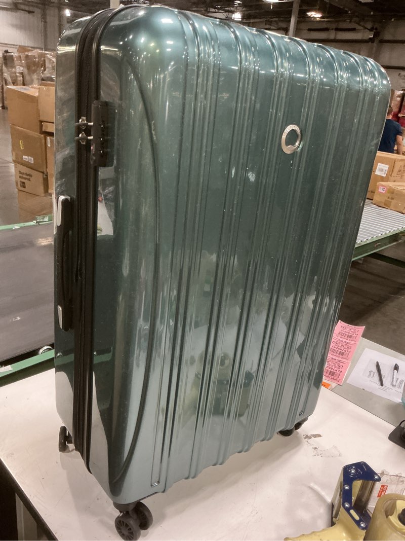 Condition photo showing Good Condition for DELSEY PARIS Helium Aero Hardside Expandable Luggage with Spinner Wheels, Metallic Green, Checked-Large 28 Inch Metallic Green Checked-Large 28 Inch