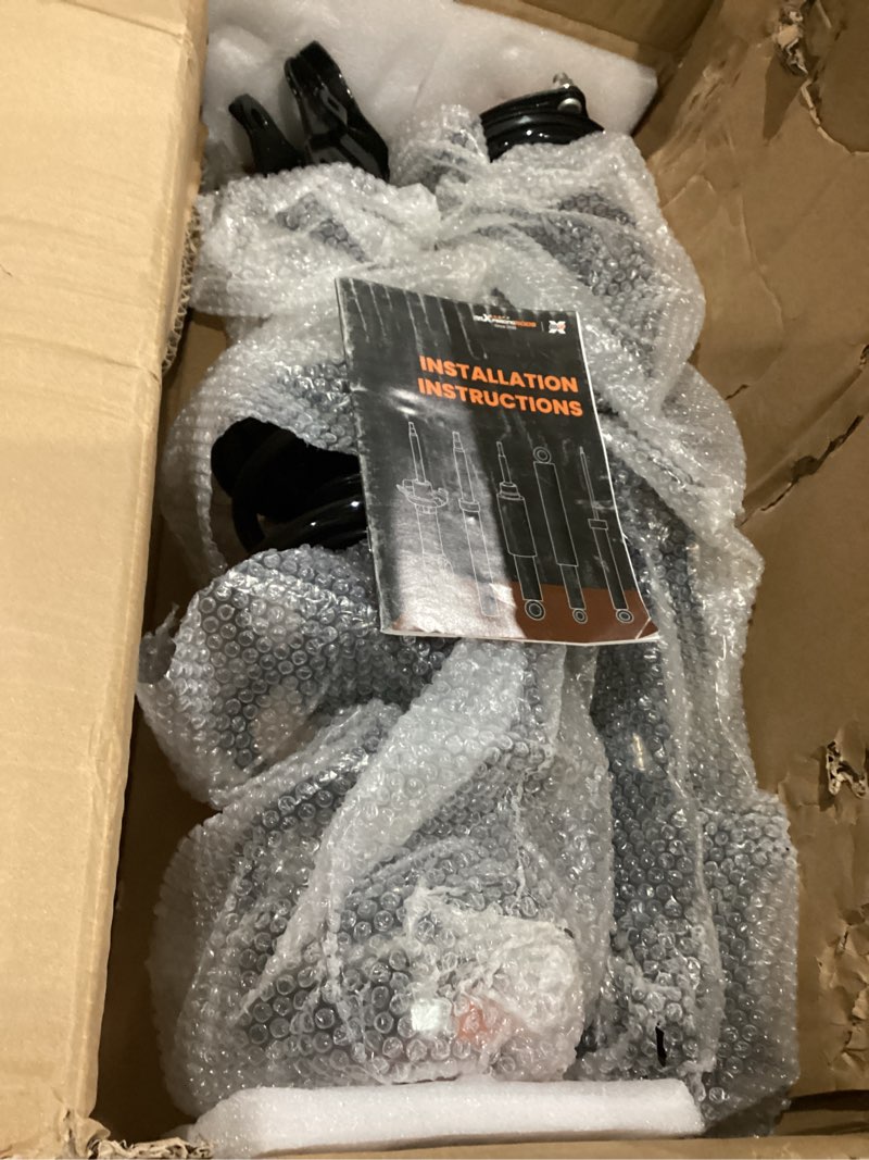 Condition photo showing As Is for strut assembly for unknown car