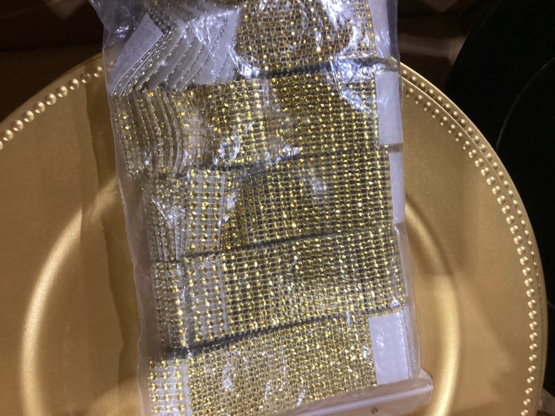 Condition photo showing As Is for 47 decorative disposable plastic shrink wrap coated plates with decorative bedazzled hook and loop fastening strips
