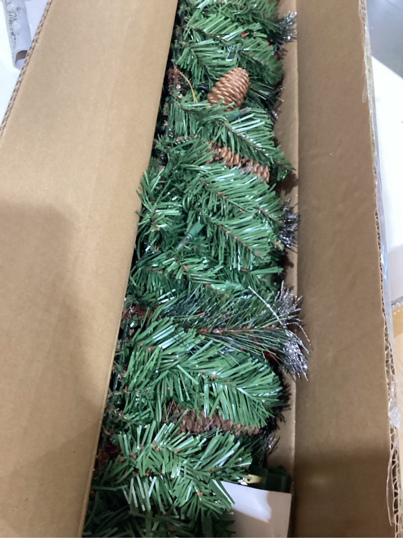 Condition photo showing Good Condition for national tree company 9 ft pre-lit crestwood spruce artificial christmas garland, christmas decoration with glitter, pinecones, red berries, 50 clear lights, 180 tips, green plug in tree