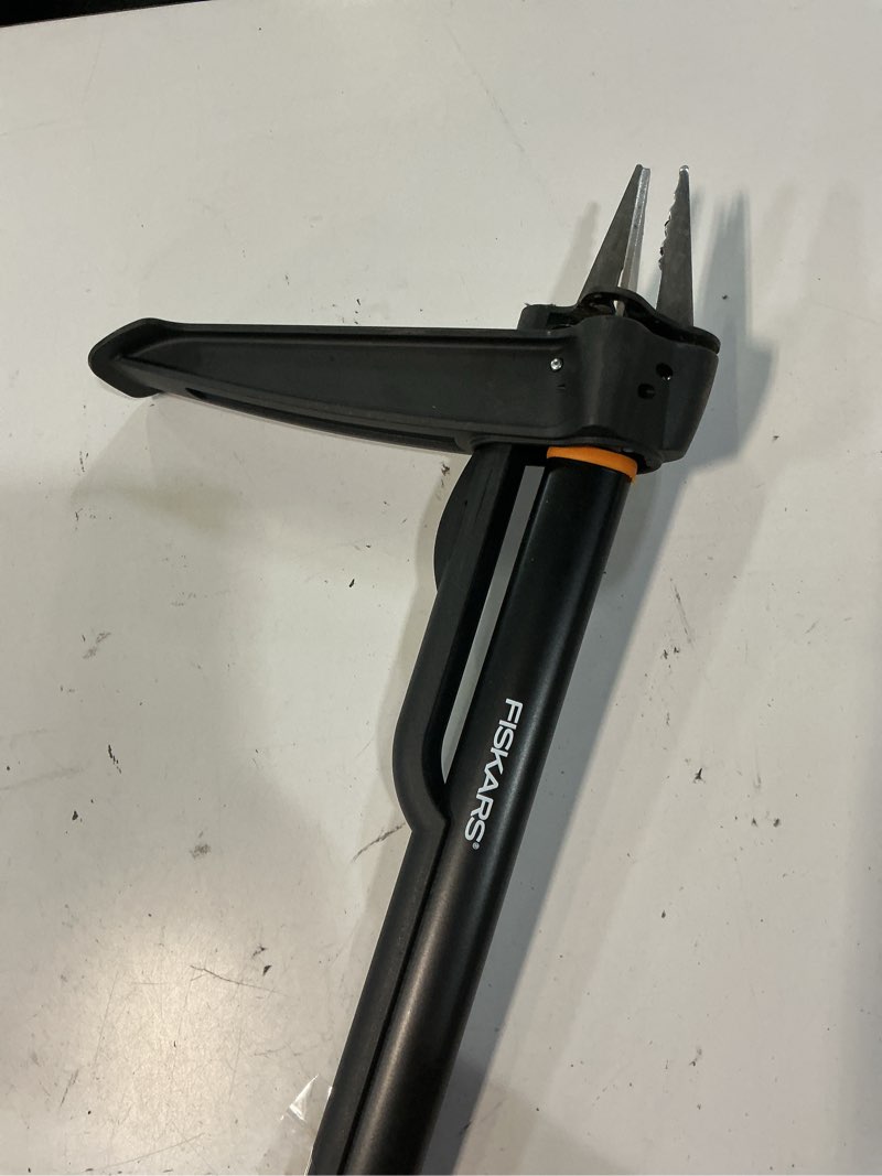 Condition photo showing As Is for fiskars stand-up weed puller tool, 4 serrated stainless steel claws grip roots for permanent removal, reinforced foot platform penetrates tough soil, easy-eject & ergonomic offset handle, 39"