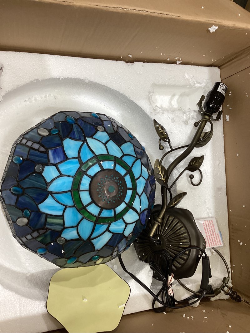 Blue stained glass Tiffany-style lamp featuring a dragonfly