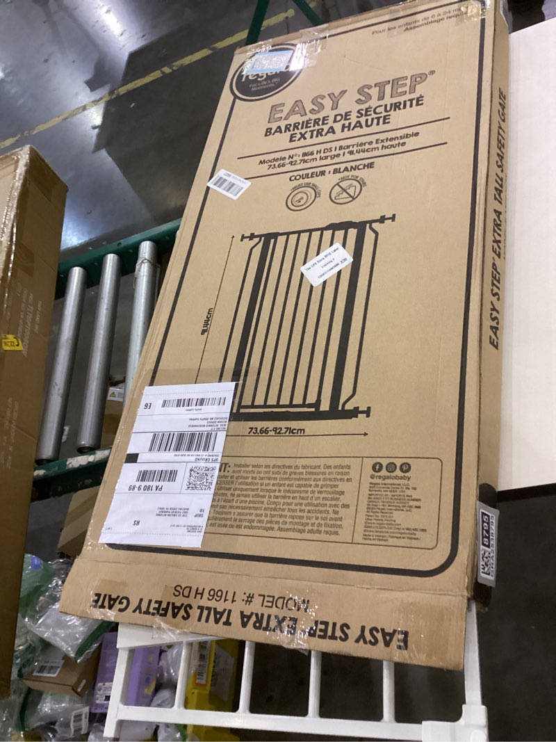 Condition photo showing As Is for Regalo Easy Step Extra Tall Walk Thru Baby Gate, Includes 4-Inch Extension, and 4 Pack of Wall Cups and Mounting Kit, White White 29-36.5"W x 36"H