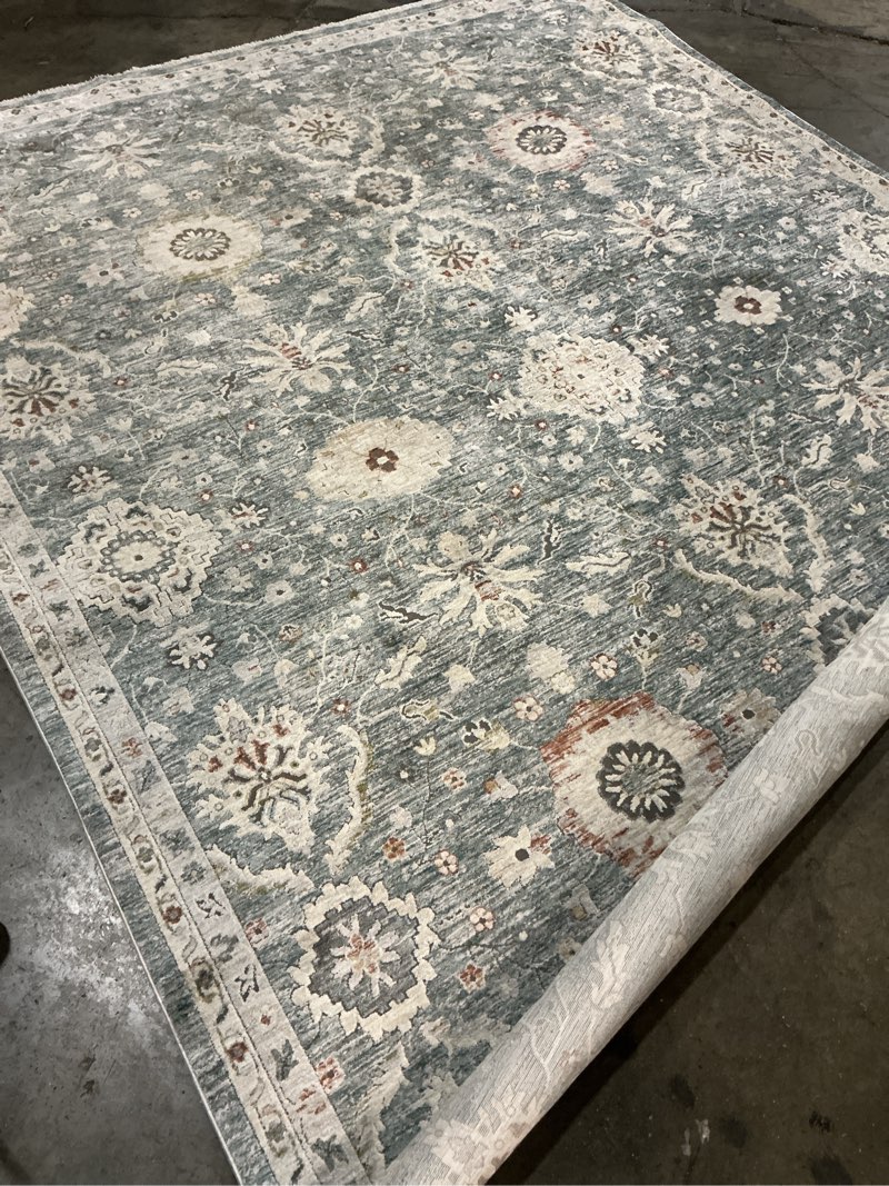 Condition photo showing As Is for allen + roth with stainmaster sapphire petals 8 x 10 (ft) blue indoor area rug