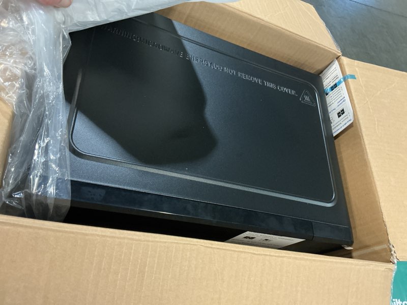 Condition photo showing As Is for mainstays 0.7 cu ft countertop microwave oven, 700 watts, black