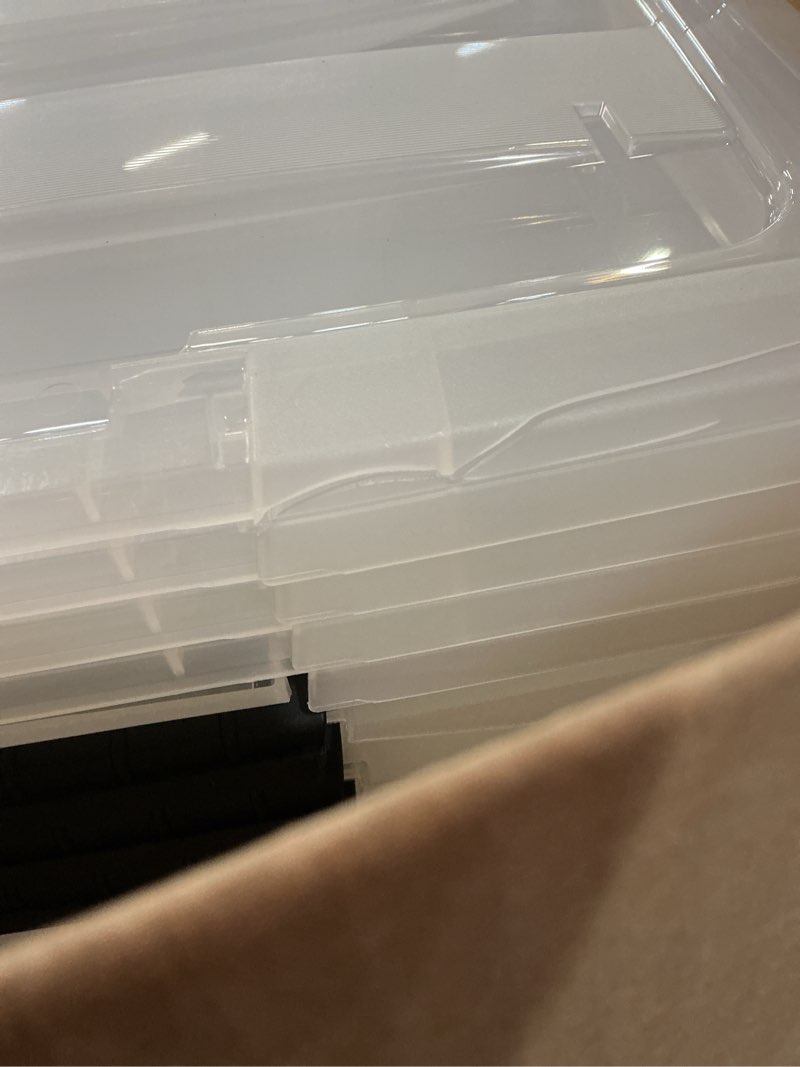 Condition photo showing As Is for iris usa 4-pack 72 quart storage bins with lids, clear | transparent design makes contents easy to find. perfect for moving, blankets, clothing, and garage storage. nestable design clear 72 qt 4 pack