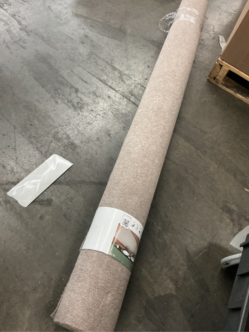 Condition photo showing As Is for trafficmaster ribbed taupe 6 ft. x 8 ft. indoor/outdoor area rug