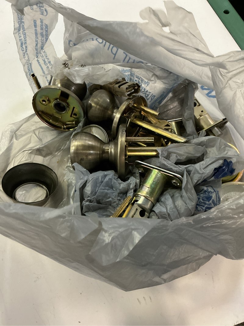 Condition photo showing As Is for tylo antique brass exterior entry door knob and single cylinder deadbolt project pack