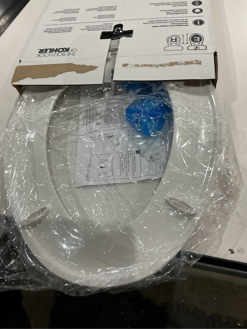 Condition photo showing As Is for kohler k-20110-0 brevia elongated toilet seat with grip-tight bumpers, quiet-close seat, quick-attach hardware, white