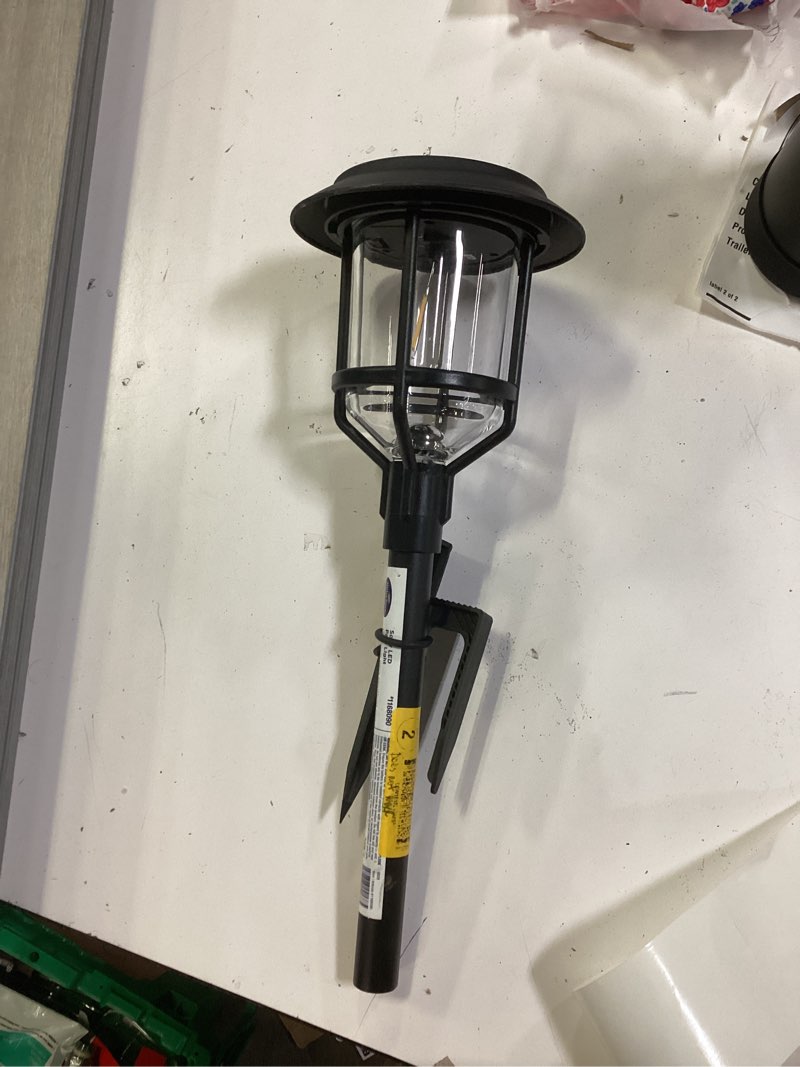 Condition photo showing As Is for harbor breeze path light 15 -lumens 0.2 -watt black solar led outdoor path light ( 3000-k )