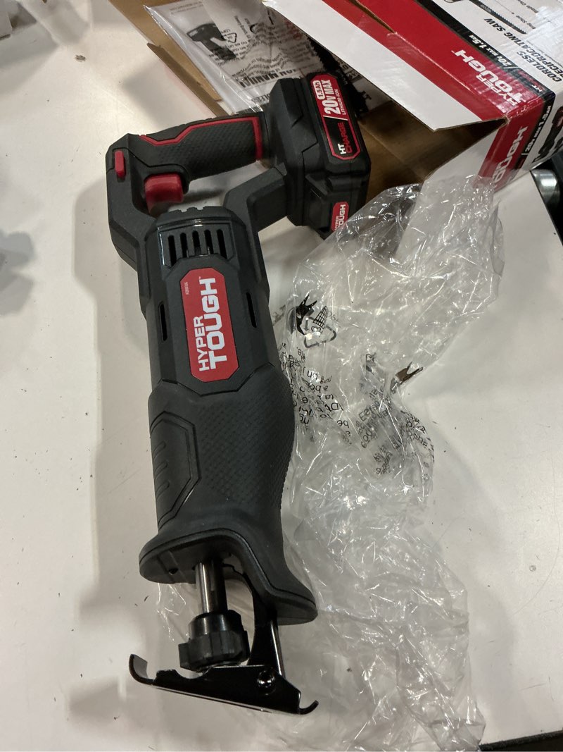 Condition photo showing As Is for hyper tough 20v max lithium-ion cordless reciprocating saw, variable speed, keyless blade change, with 1.5ah lithium-ion battery and charger, wood blade and led light