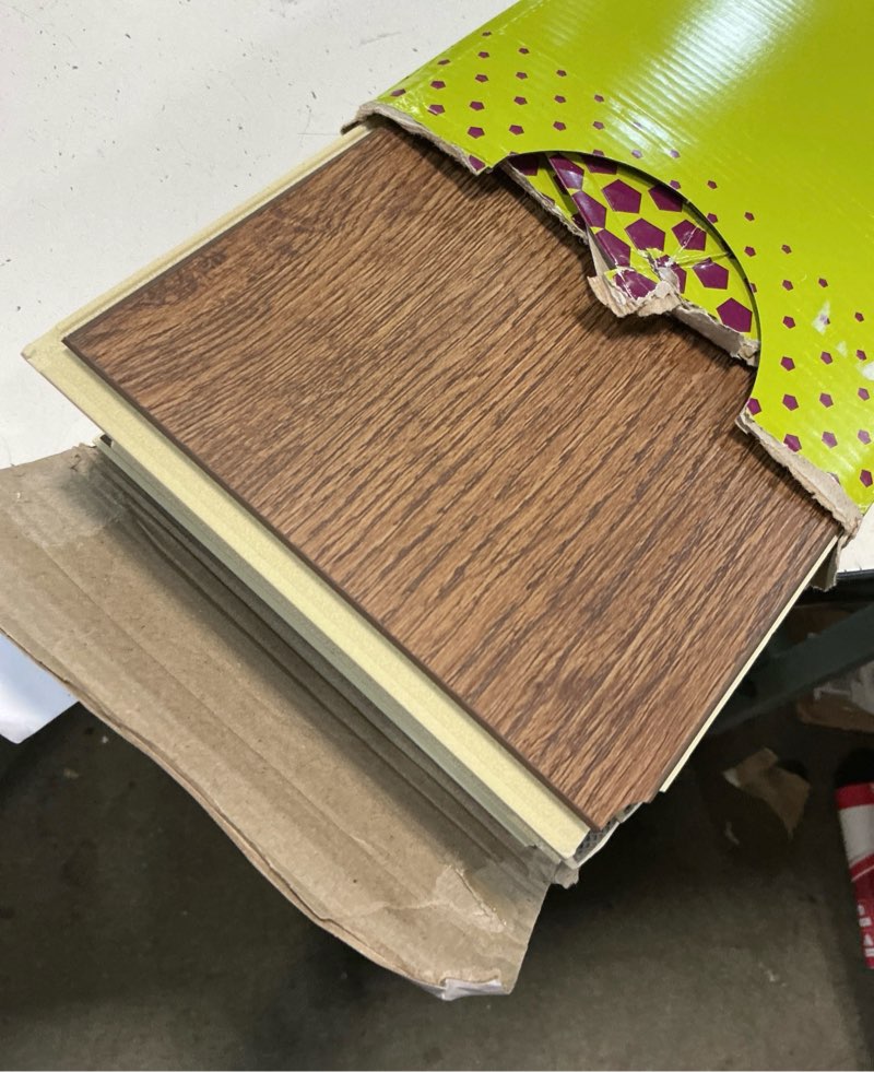 Condition photo showing As Is for smartcore by coretec floors lexington oak brown wood look 12-mil x 6-in w x 48-in l waterproof and water resistant interlocking luxury vinyl plank flooring ( 15.76-sq ft carton )