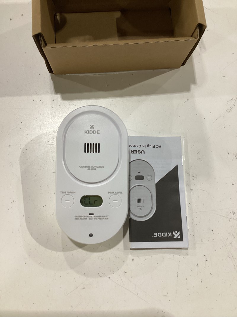 Condition photo showing As Is for kidde carbon monoxide detector, plug-in with aa battery backup, easy-to-read digital backlit display, 85 db alarm, rotating plug, led status light indicators, 5th edition, copd 1 pack 5th edition