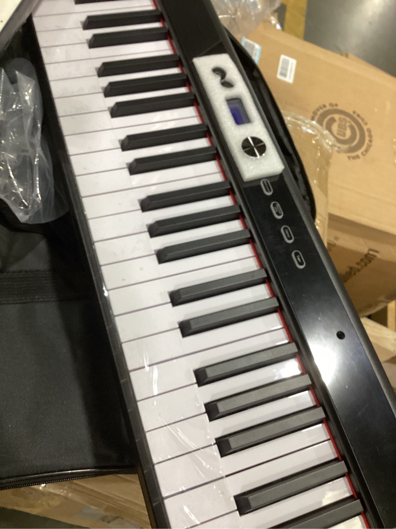 Condition photo showing Good Condition for coolmusic folding piano keyboard , portable electric keyboard with midi, full size digital piano, wood grain, semi-weighted, rechargeable, with storage bag for beginner black