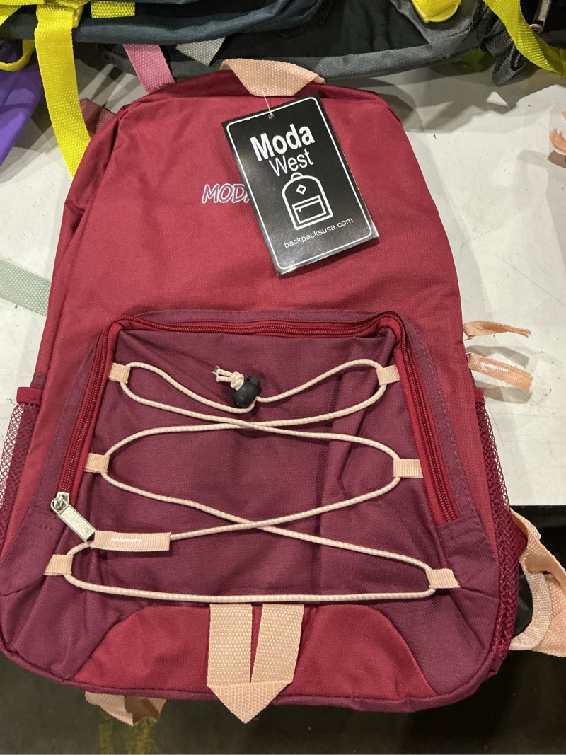 Condition photo showing New/Like New for this appears to be a red moda west backpack featuring a front zippered compartment with a decorative bungee cord lacing detail.