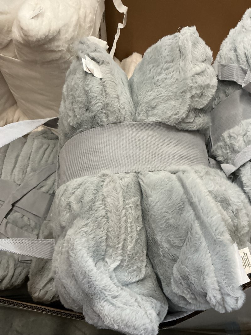 Condition photo showing New/Like New for member's mark 2-pack ruched faux fur decorative pillows, 22" x 22"