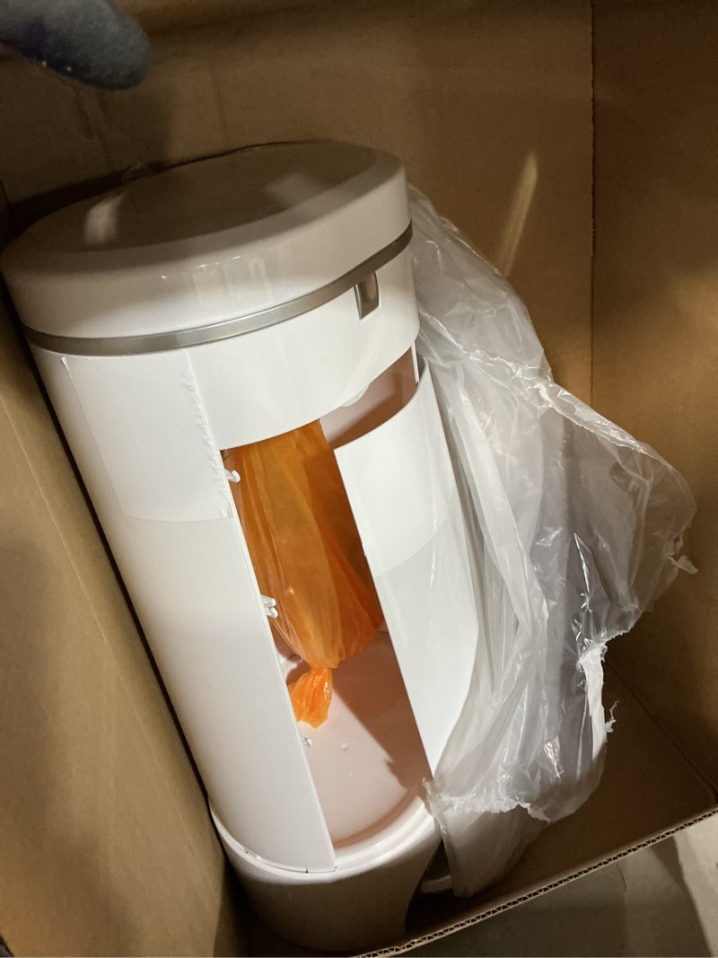 Condition photo showing As Is for munchkin® step™ diaper pail powered by arm & hammer, #1 in odor control, award-winning, includes 1 snap, seal & toss™ bag, 1 starter refill ring, and 1 puck™ baking soda cartridge