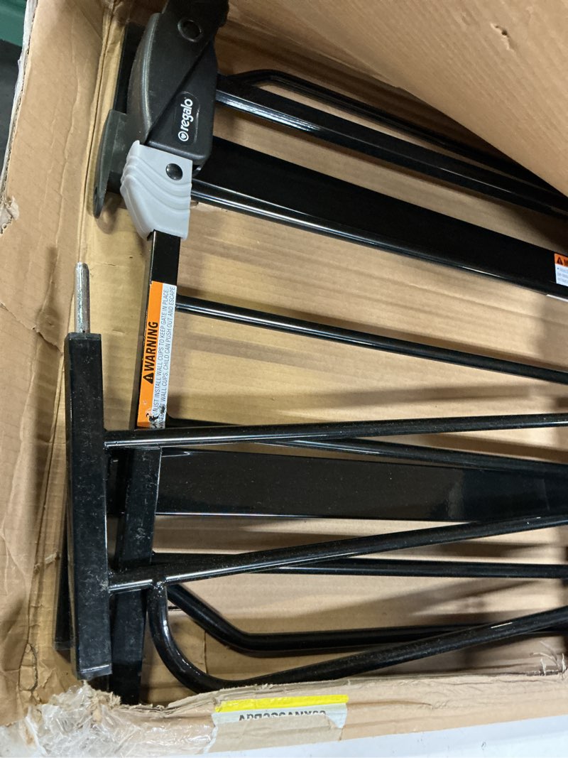 Condition photo showing As Is for regalo safety 29-38.5" baby gate for doorways & bottom of stairs, pressure mounted baby gate with door for babies, toddlers & pets, tested & safe for 30 years, american designed, american owned, black black 29-38.5"w x 30"h