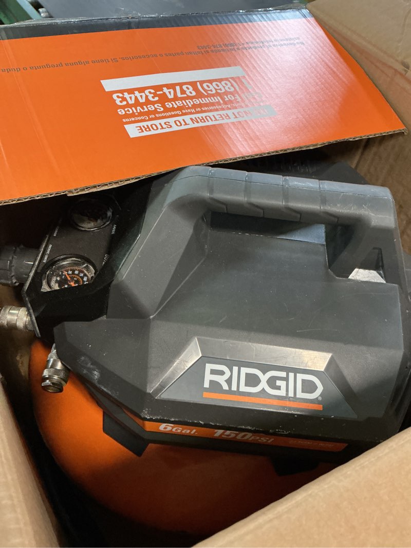 Condition photo showing As Is for ridgid 6 gal. 150 psi portable electric oil-free jobsite pancake air compressor with dual pressure gauges and 2-quick couplers