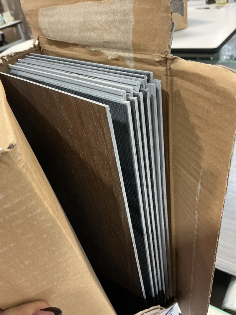 Condition photo showing As Is for style selections penny oak brown 6-mil x 6-in w x 48-in l waterproof interlocking luxury vinyl plank flooring (23.278-sq ft/ carton)