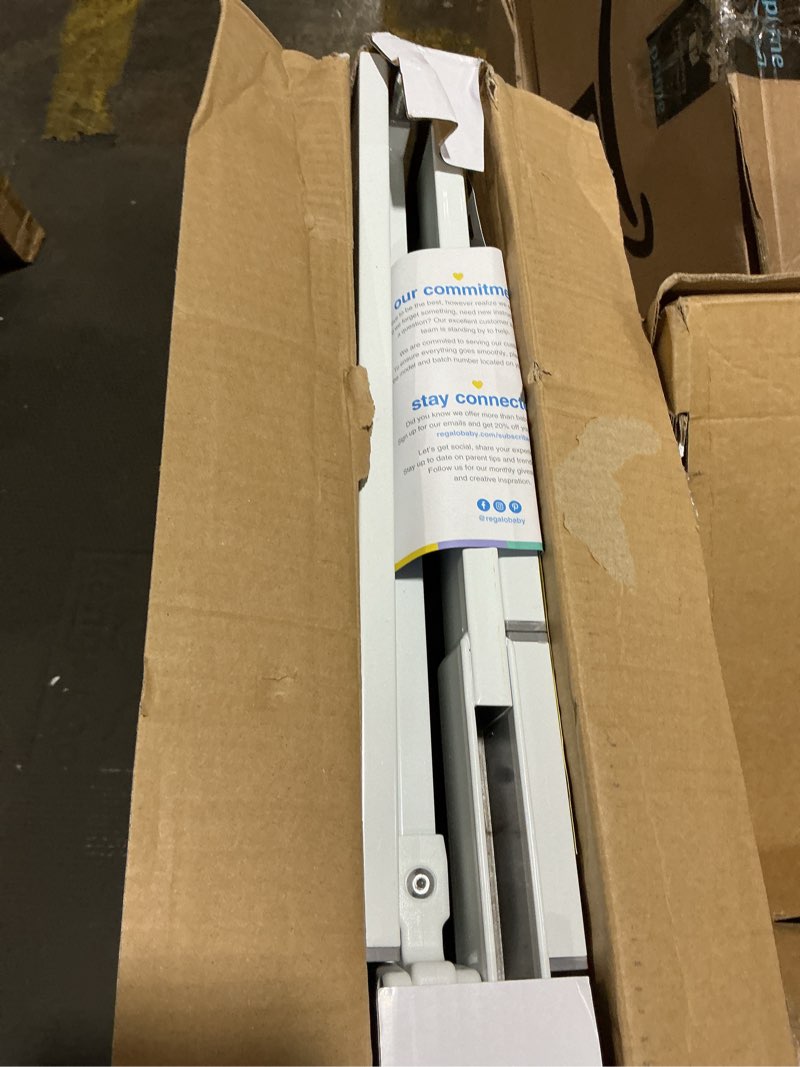Condition photo showing New/Like New for regalo safety 29-38.5" baby gate for doorways & bottom of stairs, pressure mounted baby gate with door for babies, toddlers & pets, tested & safe for 30 years, american designed, american owned, white white 29-38.5"w x 30"h