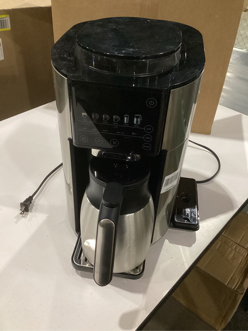 Condition photo showing As Is for **missing water reservoir*not tested**de'longhi truebrew drip coffee maker, built in grinder, single serve, 8 oz to 24 oz with 40 oz carafe, hot or iced coffee, stainless,cam51035m true brew with carafe