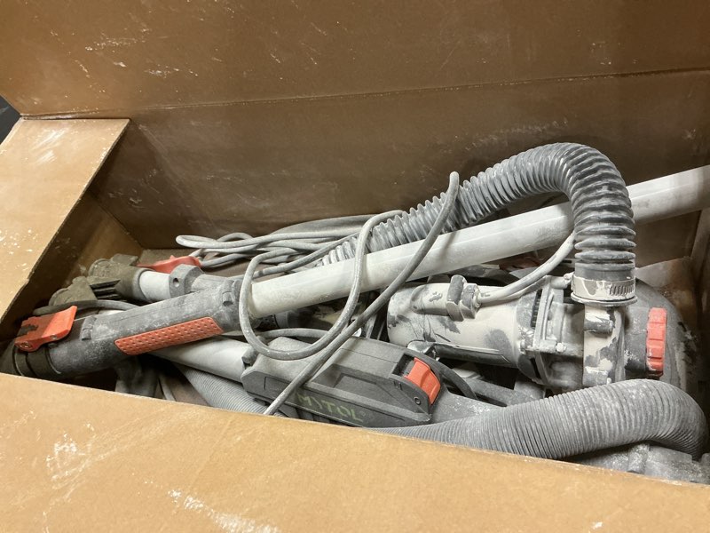 Condition photo showing As Is for electric drywall sander with vacuum dust collection, variable speed, led light, foldable handle, sanding discs & grids orange